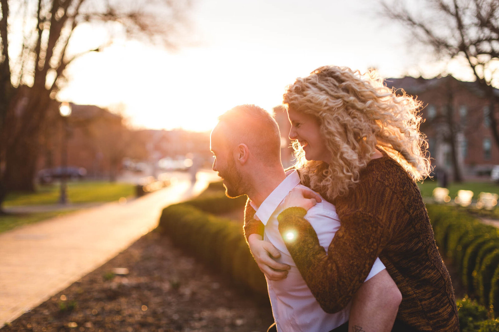 engaged couple piggy back ride in golden hour ohio photographer