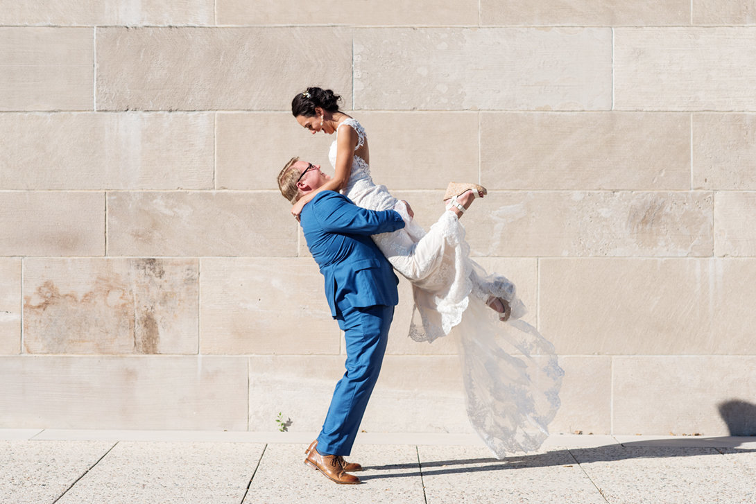 Bride jumping into grooms arms