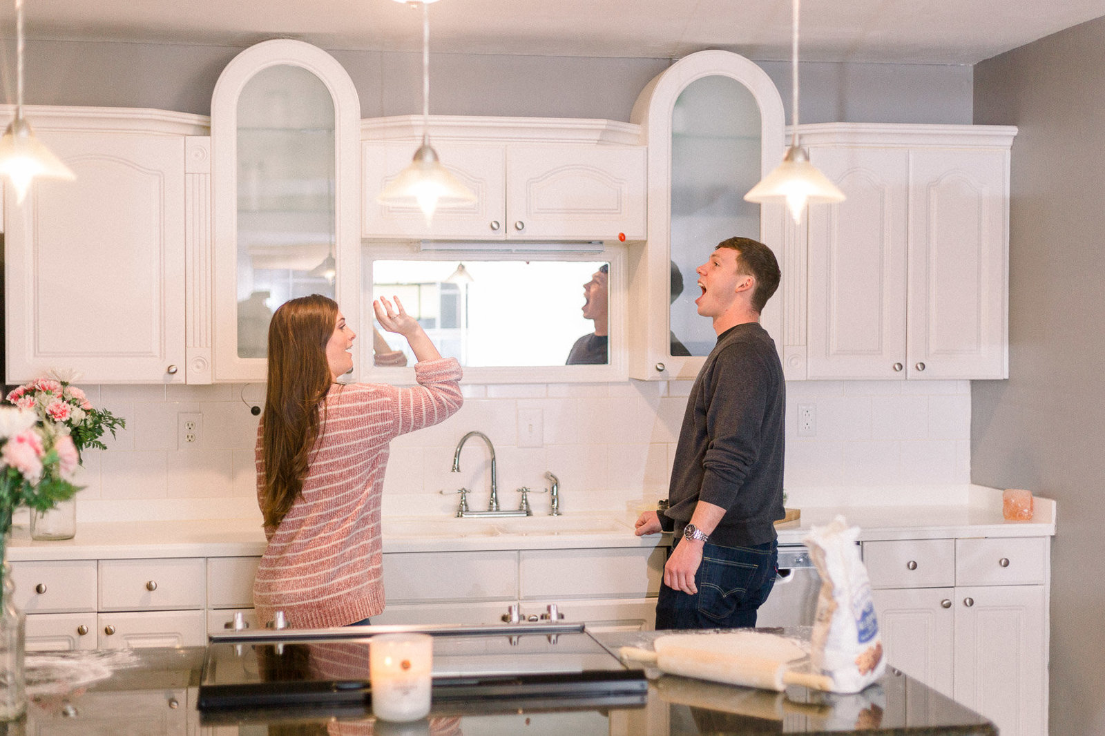 Couple having fun while making dinner captured by Staci Addison Photography