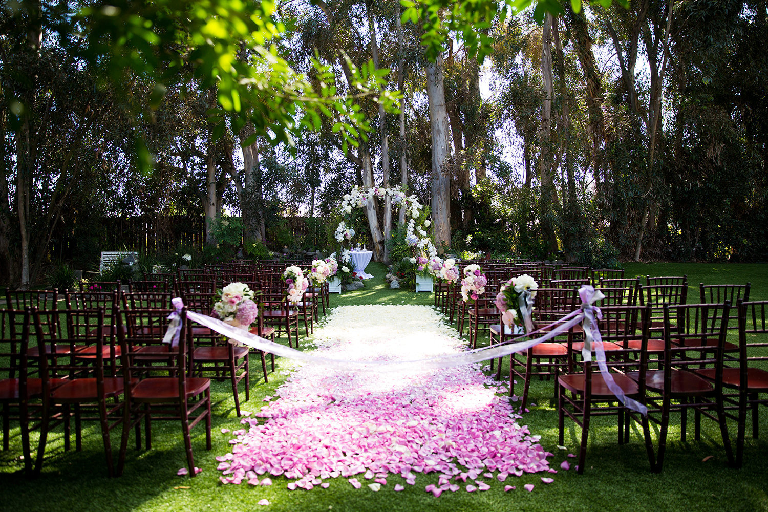 Flower petal runner for a colorful wedding ceremony site at Twin Oaks Garden Estate in San Diego