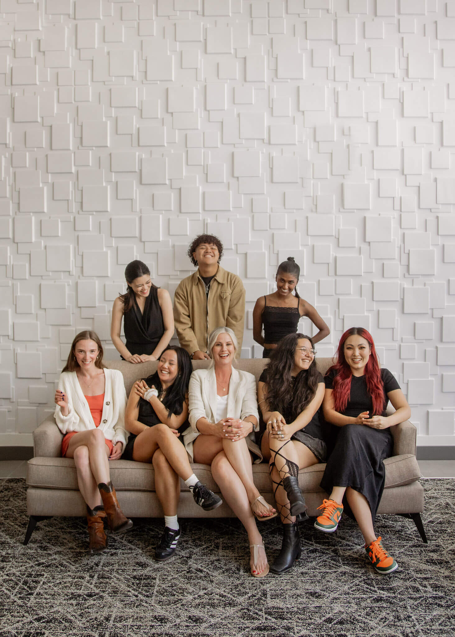 Group of fashion students sitting on a couch