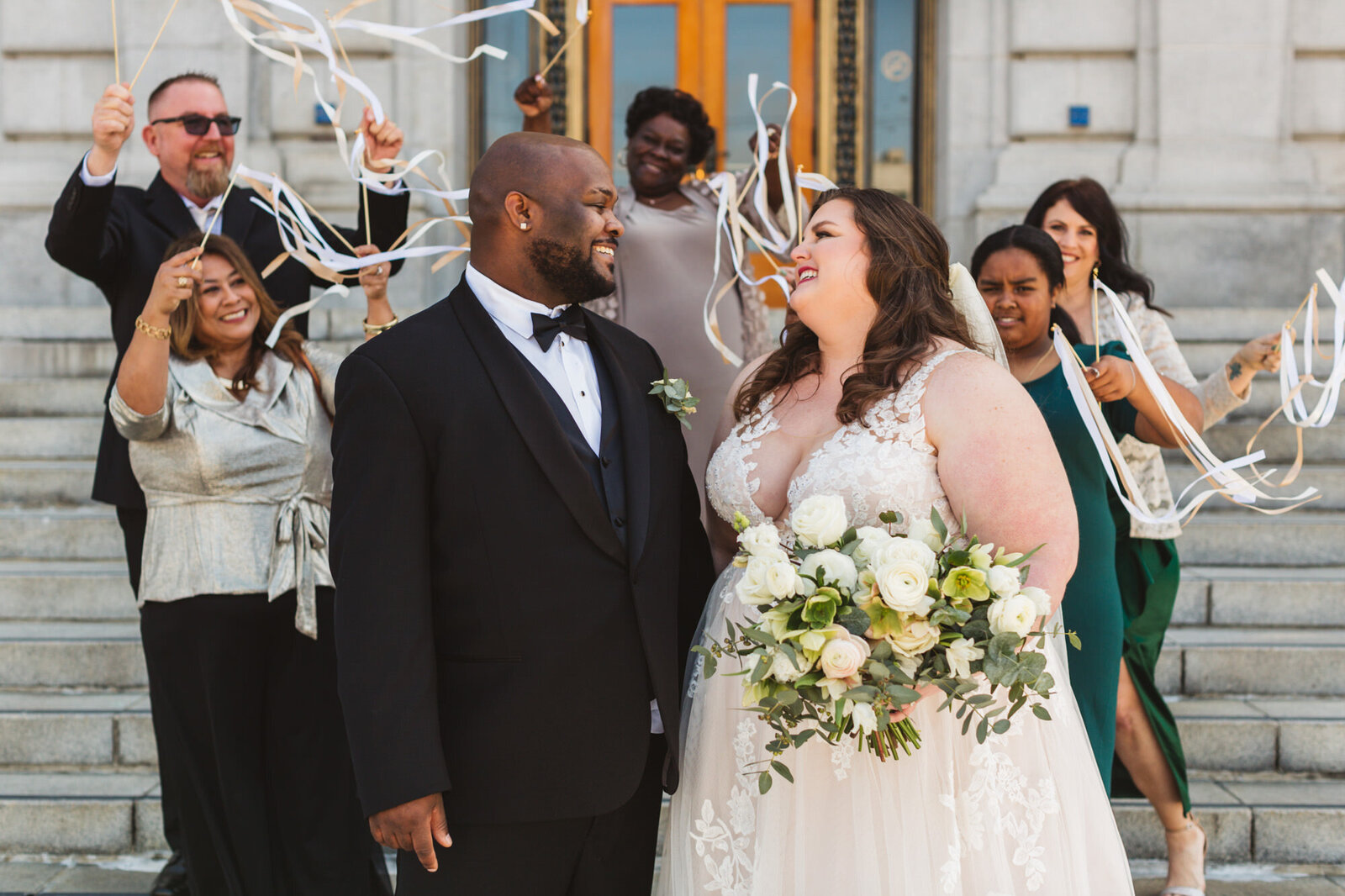 interracial couple wedding moments outside SF City Hall