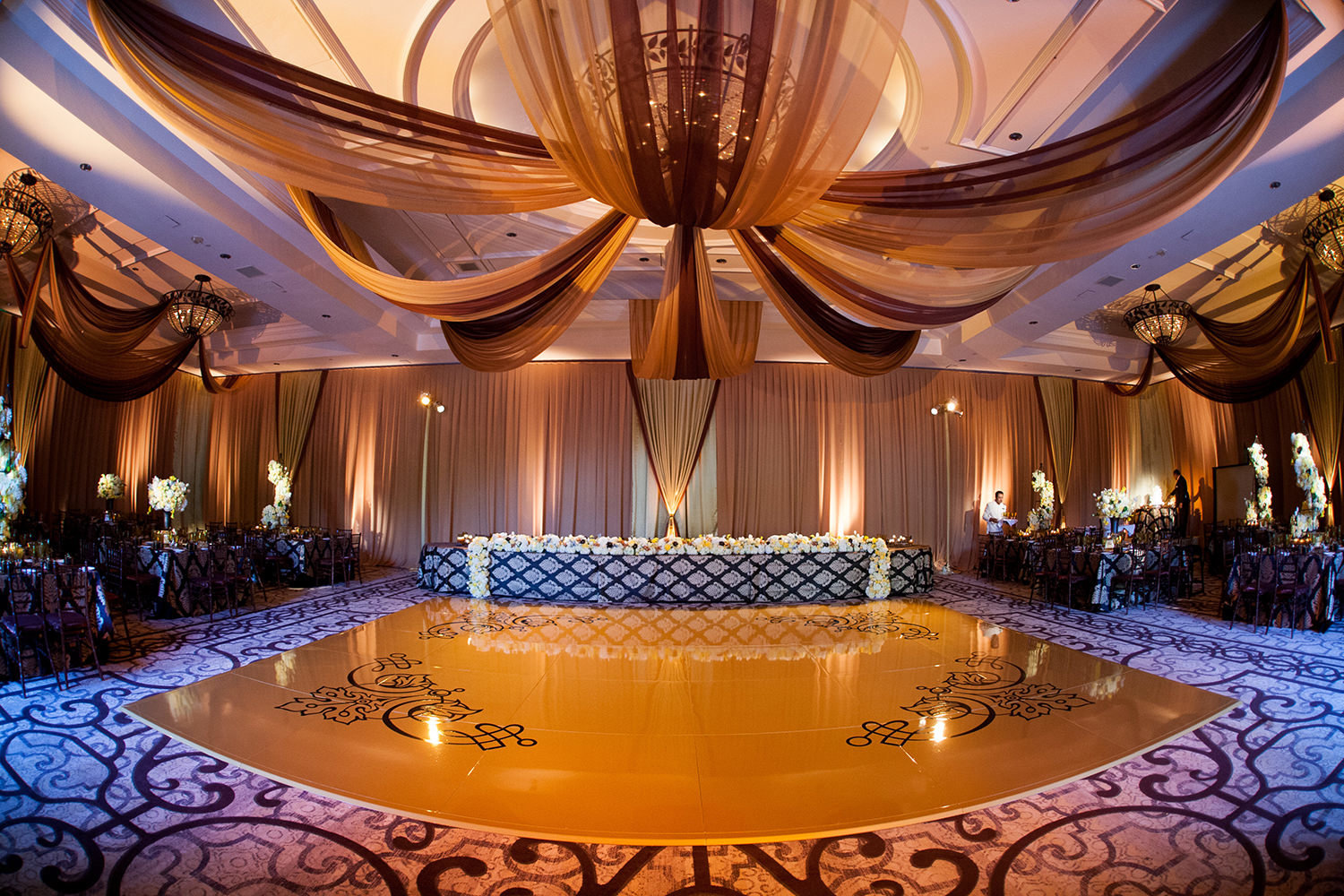 Rich colors and uplighting set a stunning scene for this wedding reception