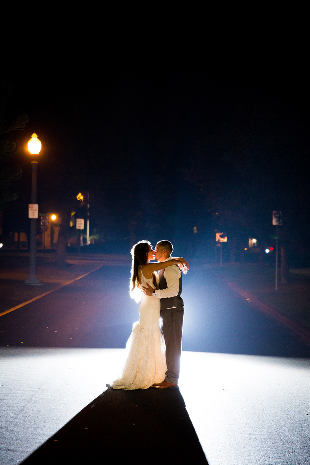 stunning night image with bride and groom at brick