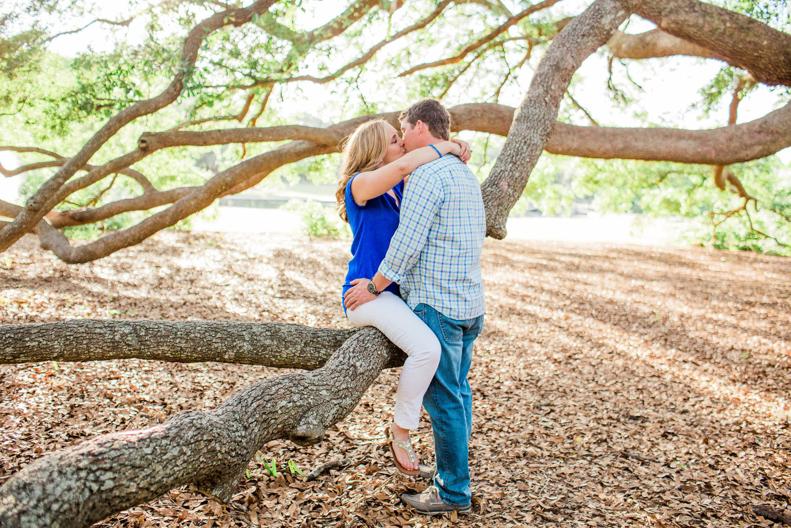Engaged couple cuddle underneath an oak tree, Hampton Park, Charleston, South Carolina