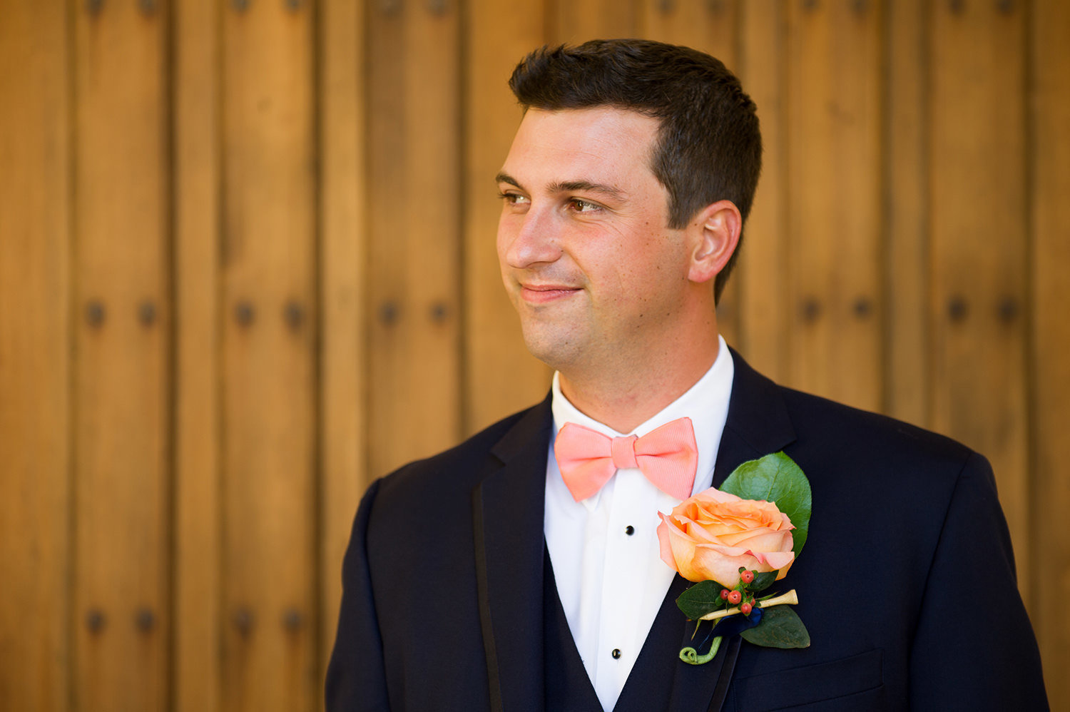groom photo with peach flower