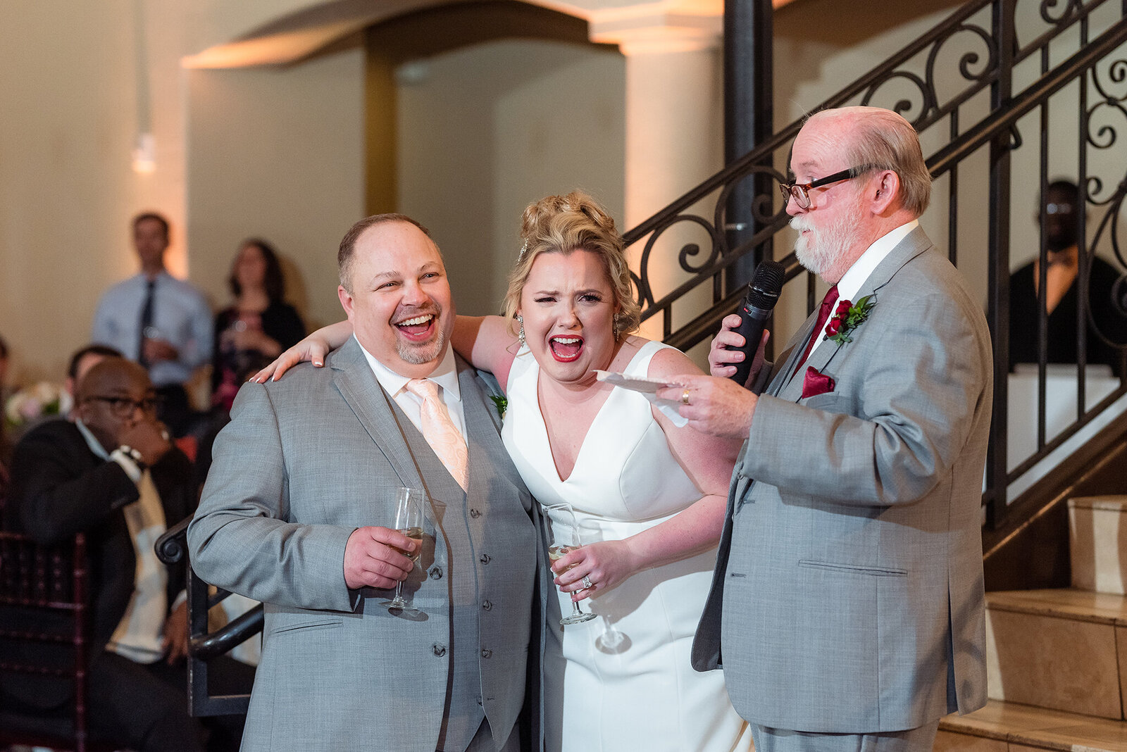Bride and groom laughing out loud during wedding speeches at Chapel at Ana Villa in Dallas Texas