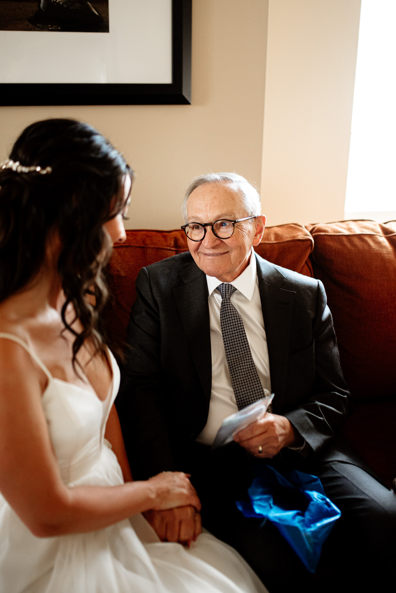 Natural shot of bride with her grandfather at her Colorado wedding.