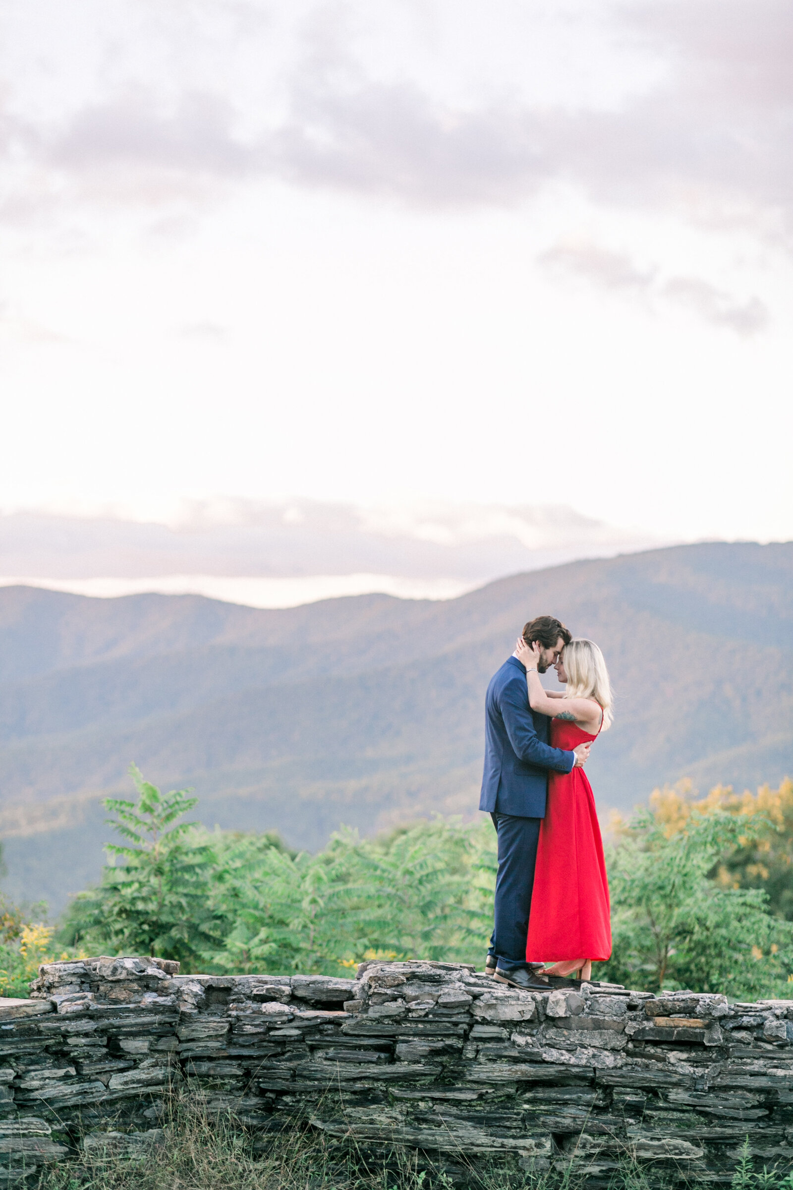 Engaged couple with a beautiful mountain view captured by Staci Addison Photography