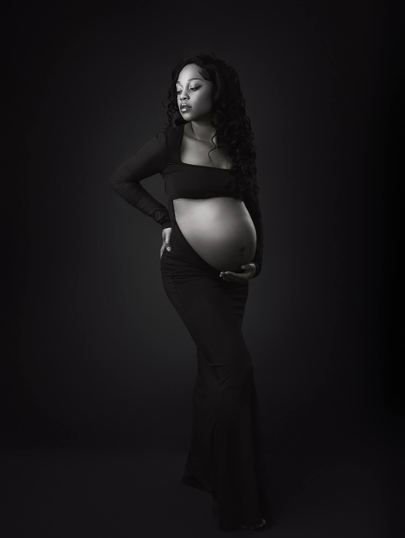 maternity mom in studio wearing black dress
