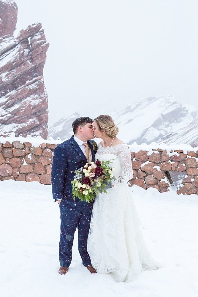 Couple in the snow at Red Rocks Park in Morrison
