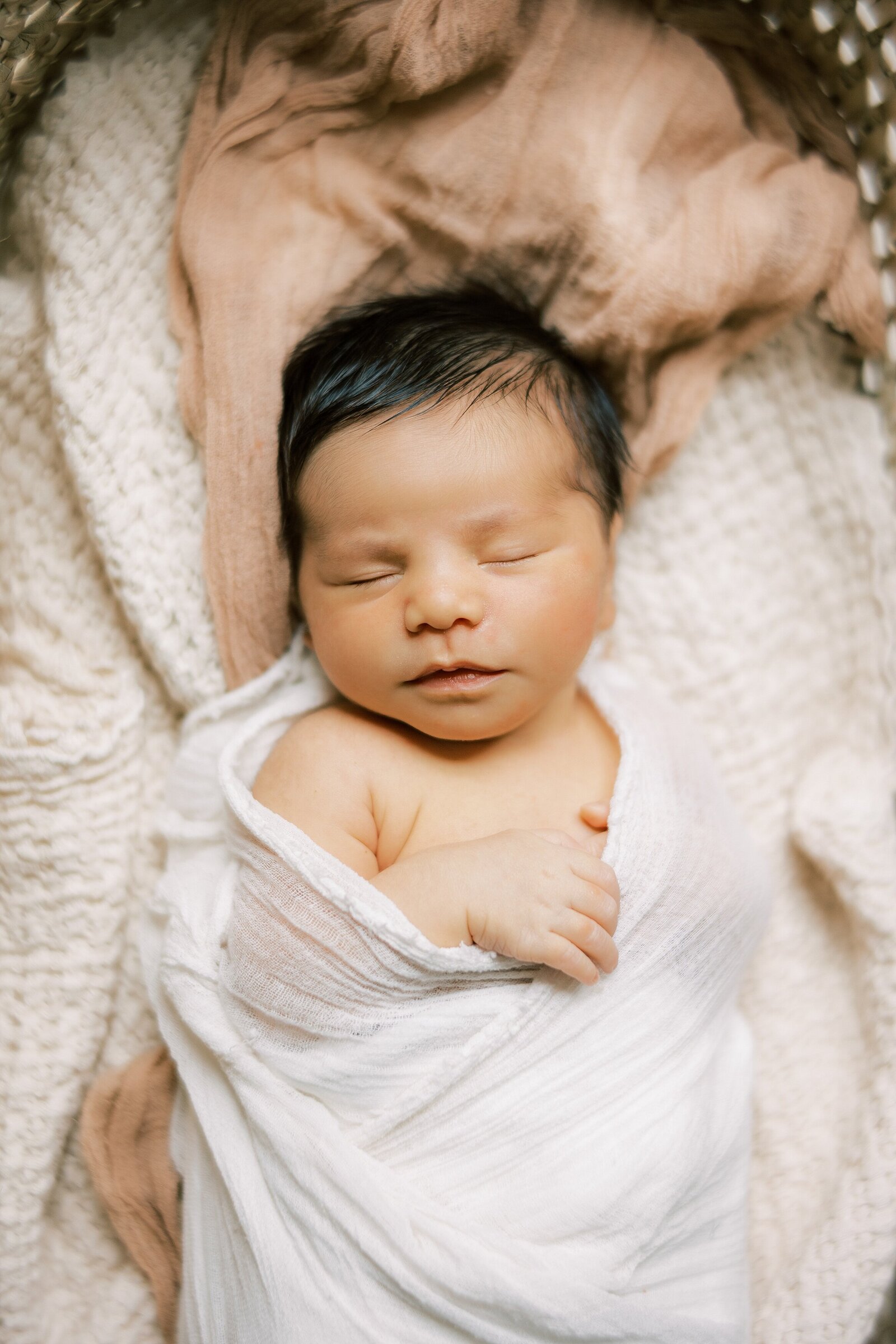 sleeping baby wrapped in white swaddle with dark hair Newborn Photography West Chester PA