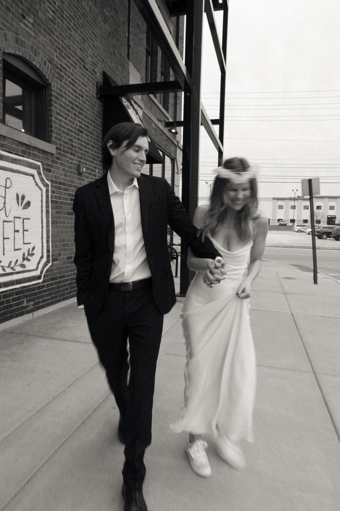 Blurry and Artful Image of Bride and Groom Laughing and Walking In Indianapolis Indiana