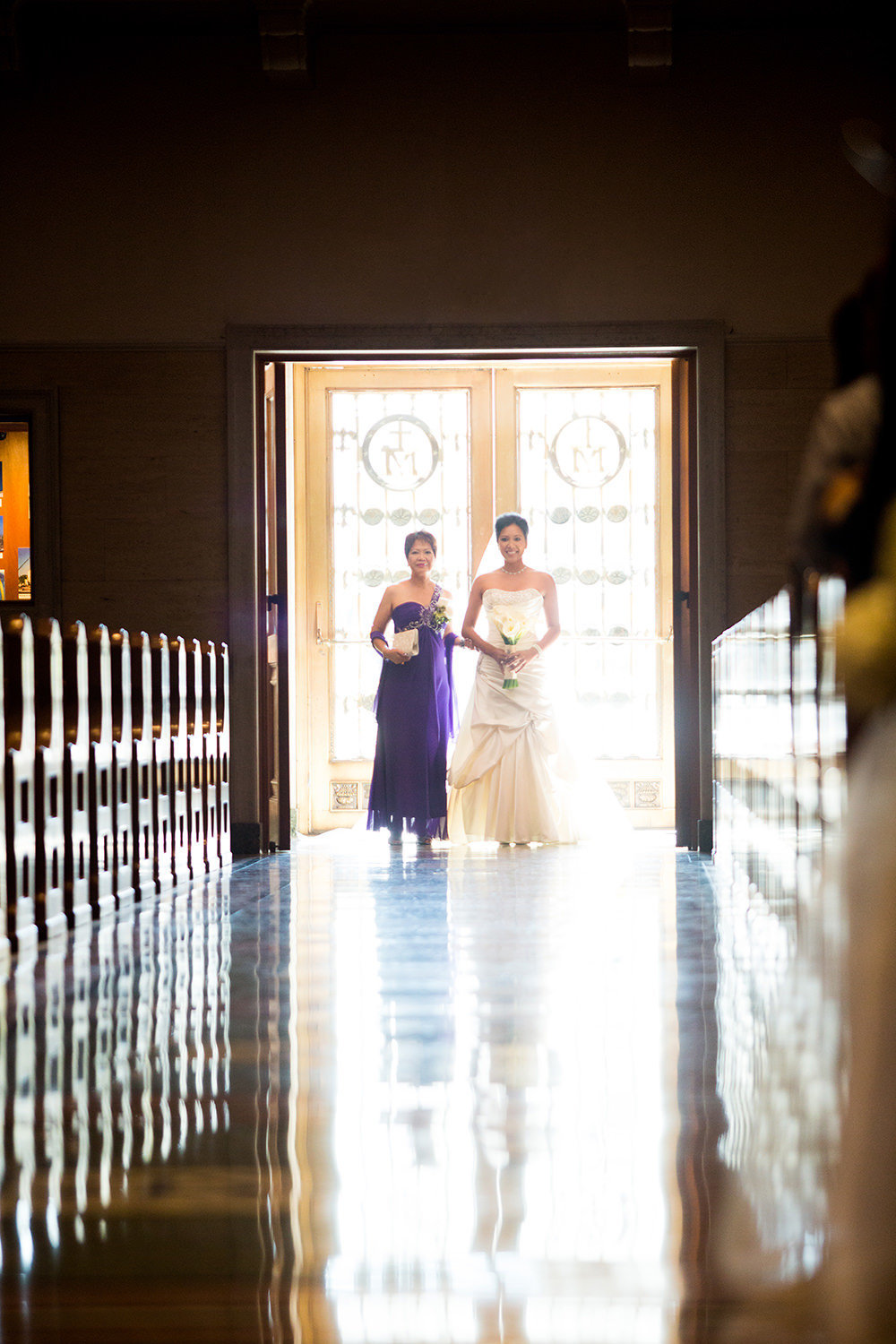 bride with mother  walking down the aisle at the immaculata