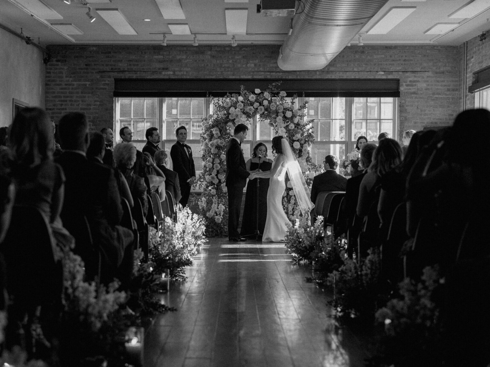 A black and white ceremony photo taken at Morgan's on Fulton in Chicago's West Loop neighborhood