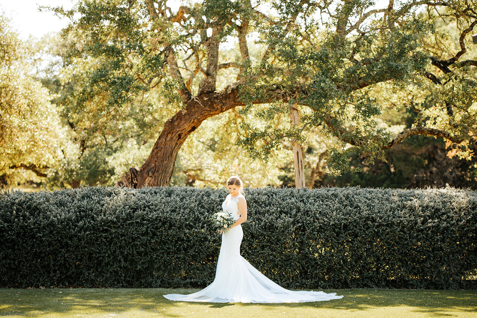 A bride poses outdoors on the Kendall Point grounds.