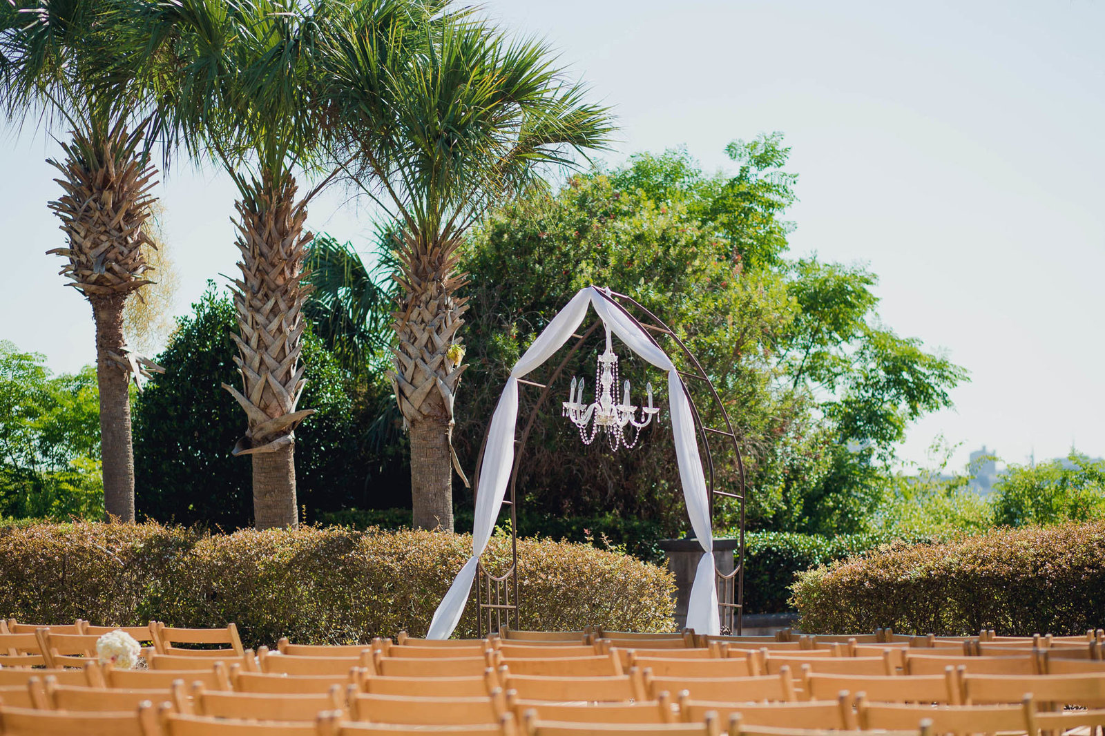 Chandelier hangs at altar by palmetto trees, Harborside East, Mt Pleasant, South Carolina