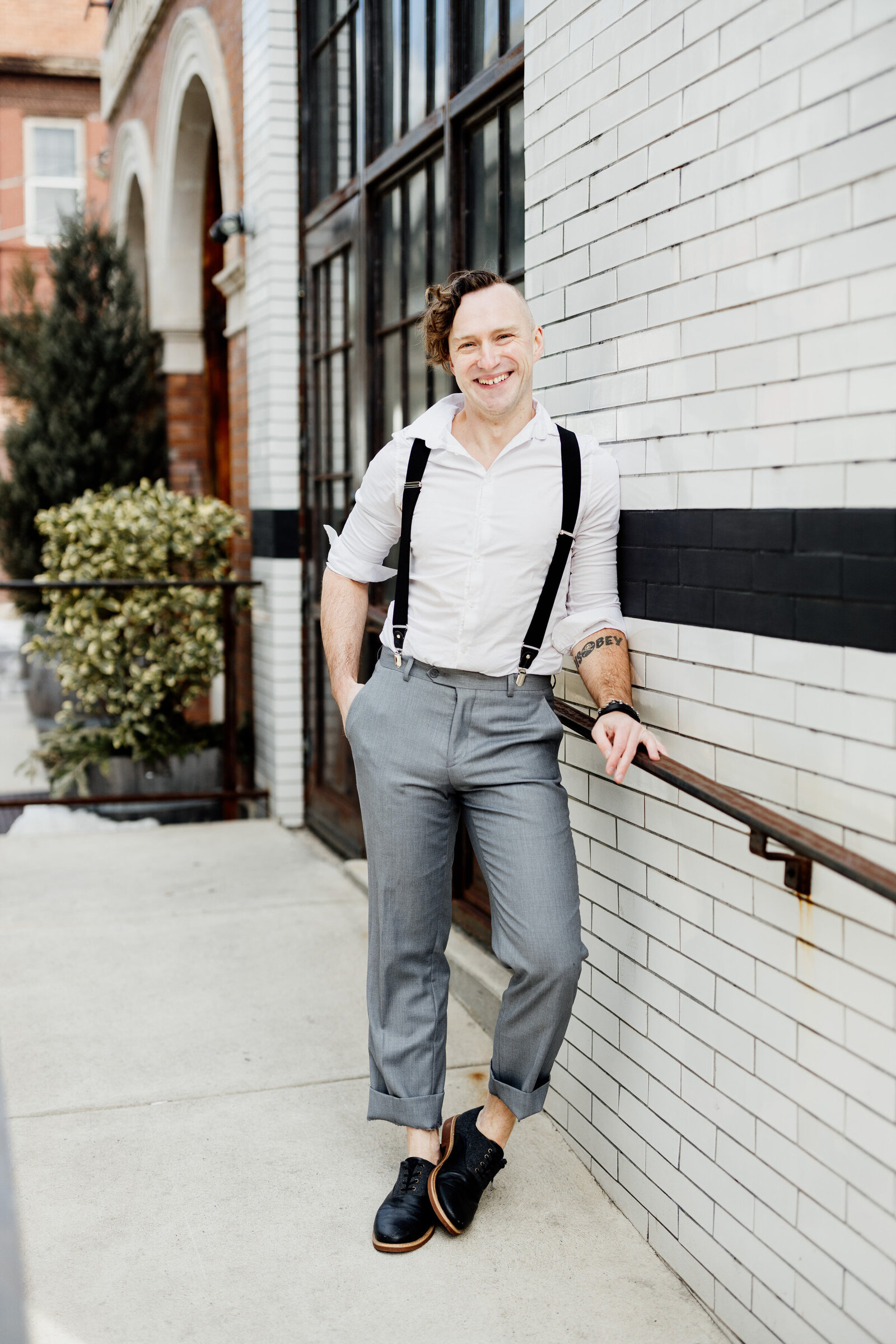 man with suspenders in city