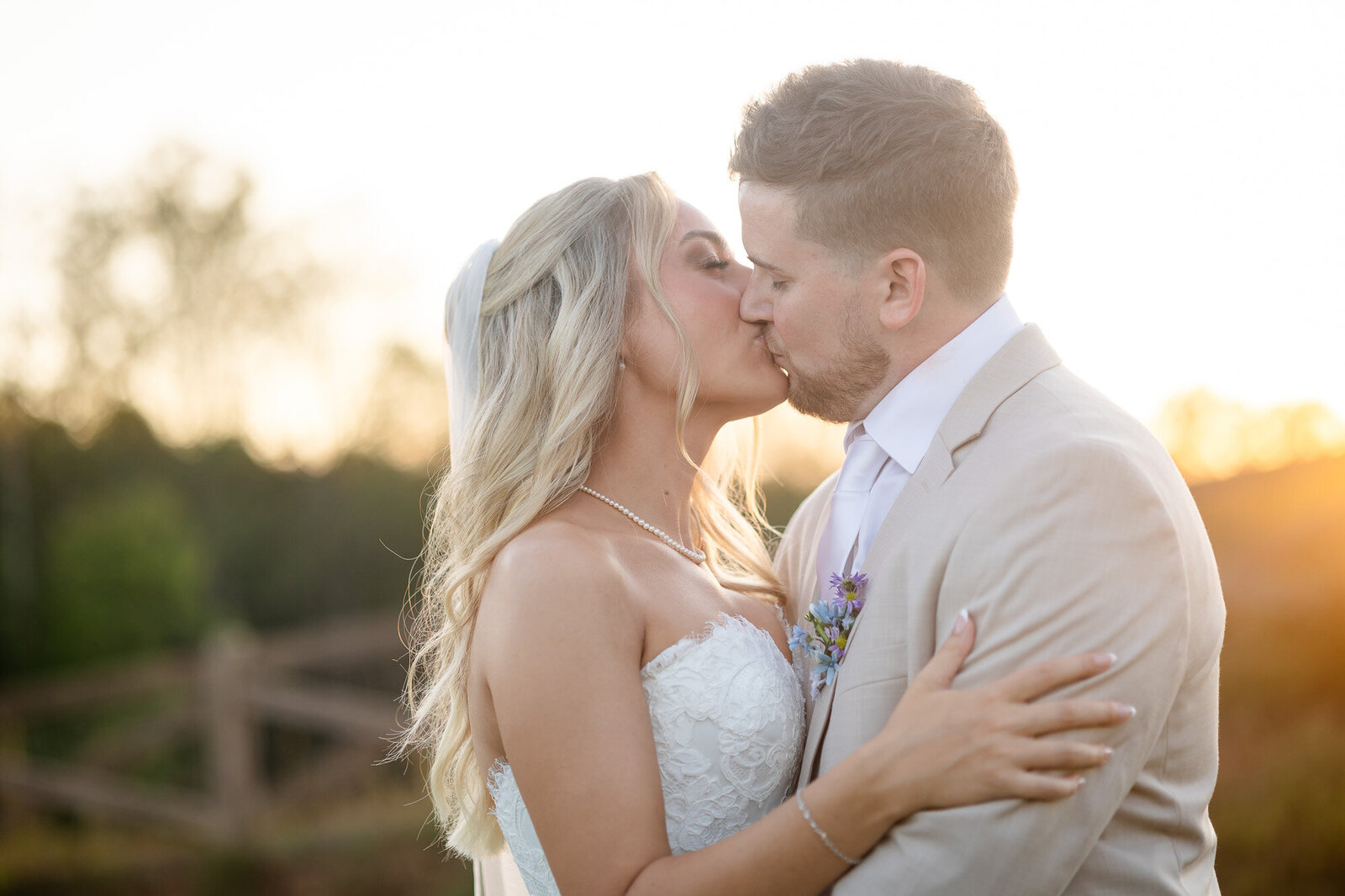 Couple sharing a kiss during golden hour in ELLIJAY . 
