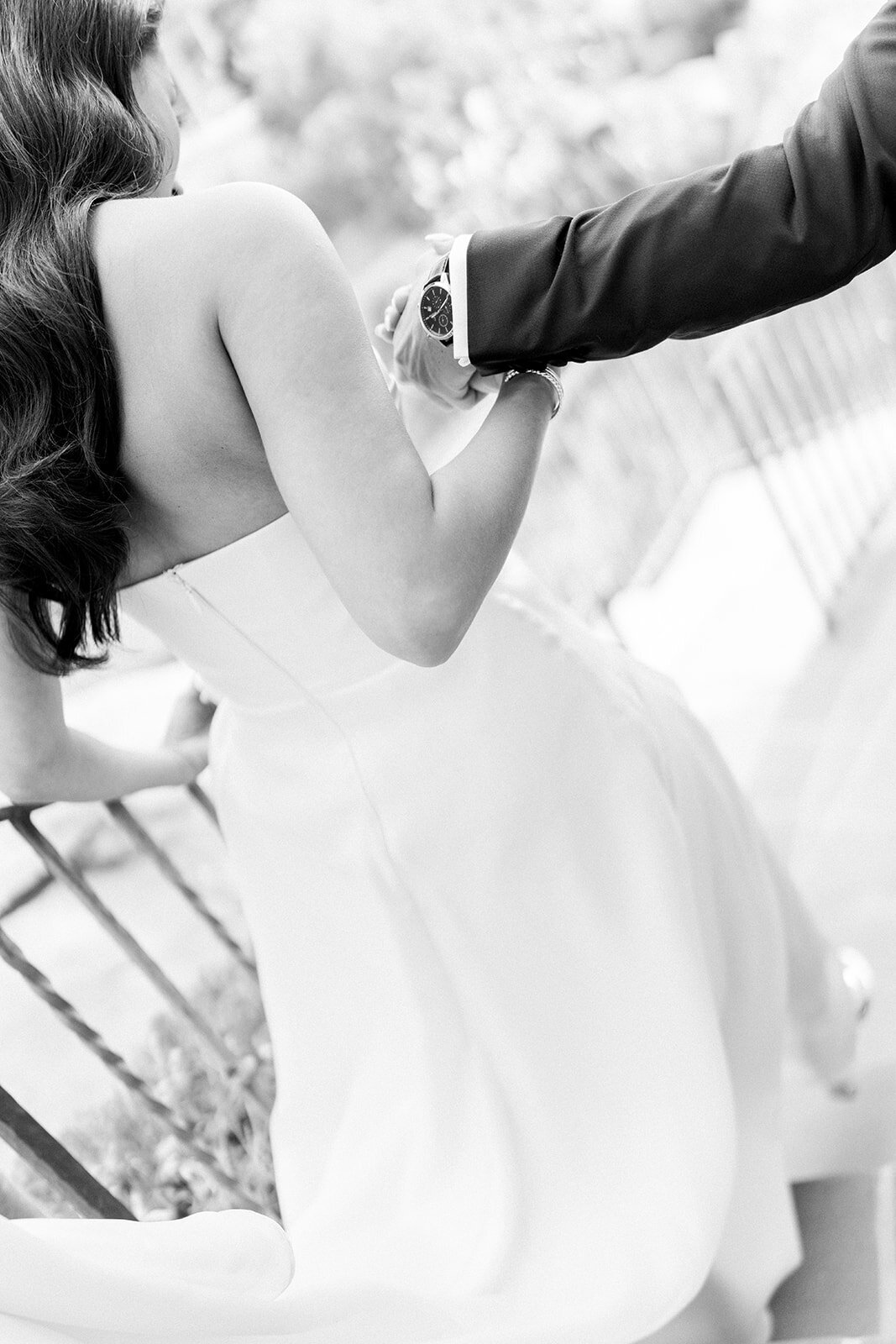 Graceful black and white image of bride’s dress billowing as she walks, captured in film for a luxury Los Angeles wedding.