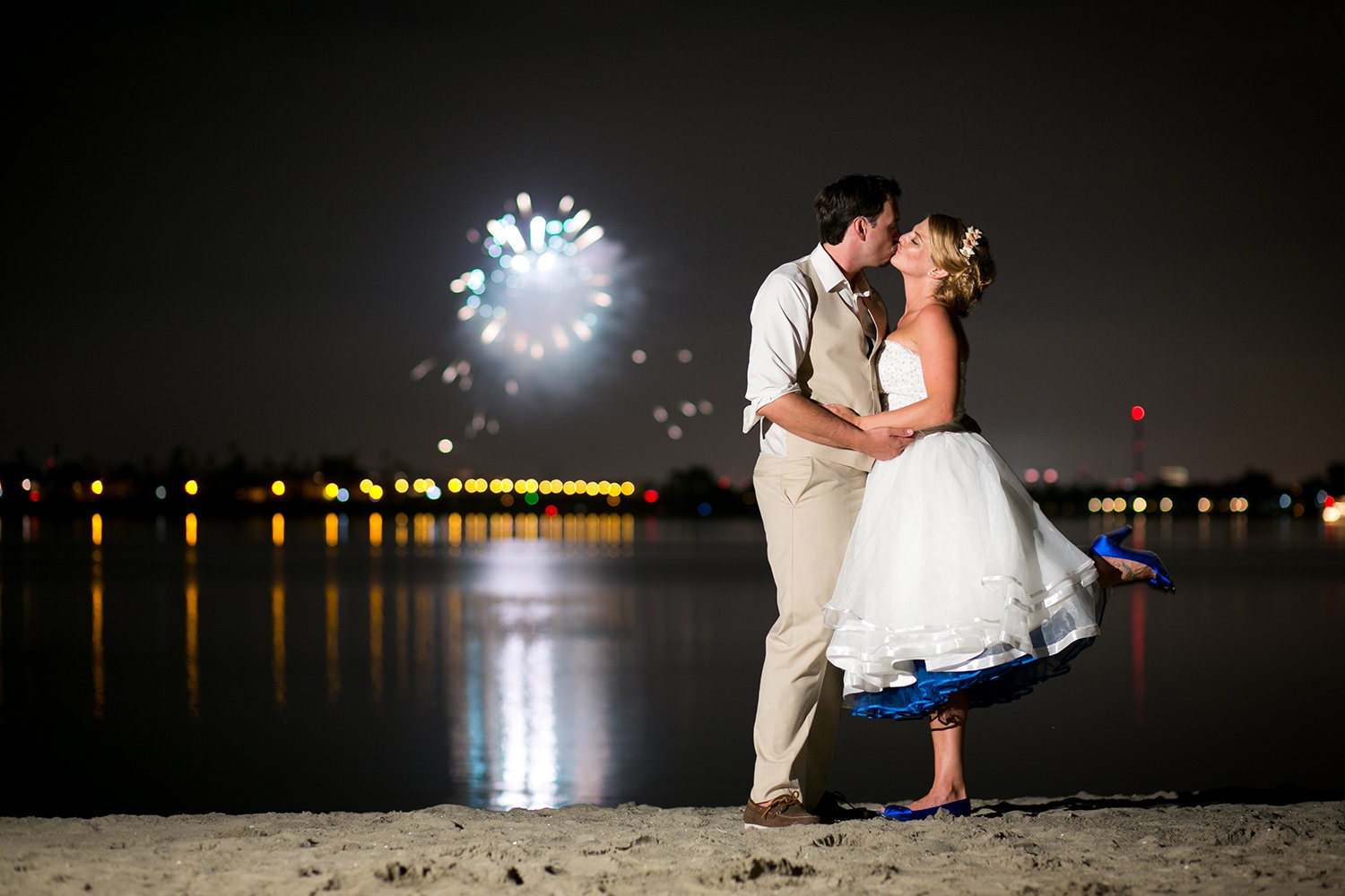 bride and groom with fireworks in background