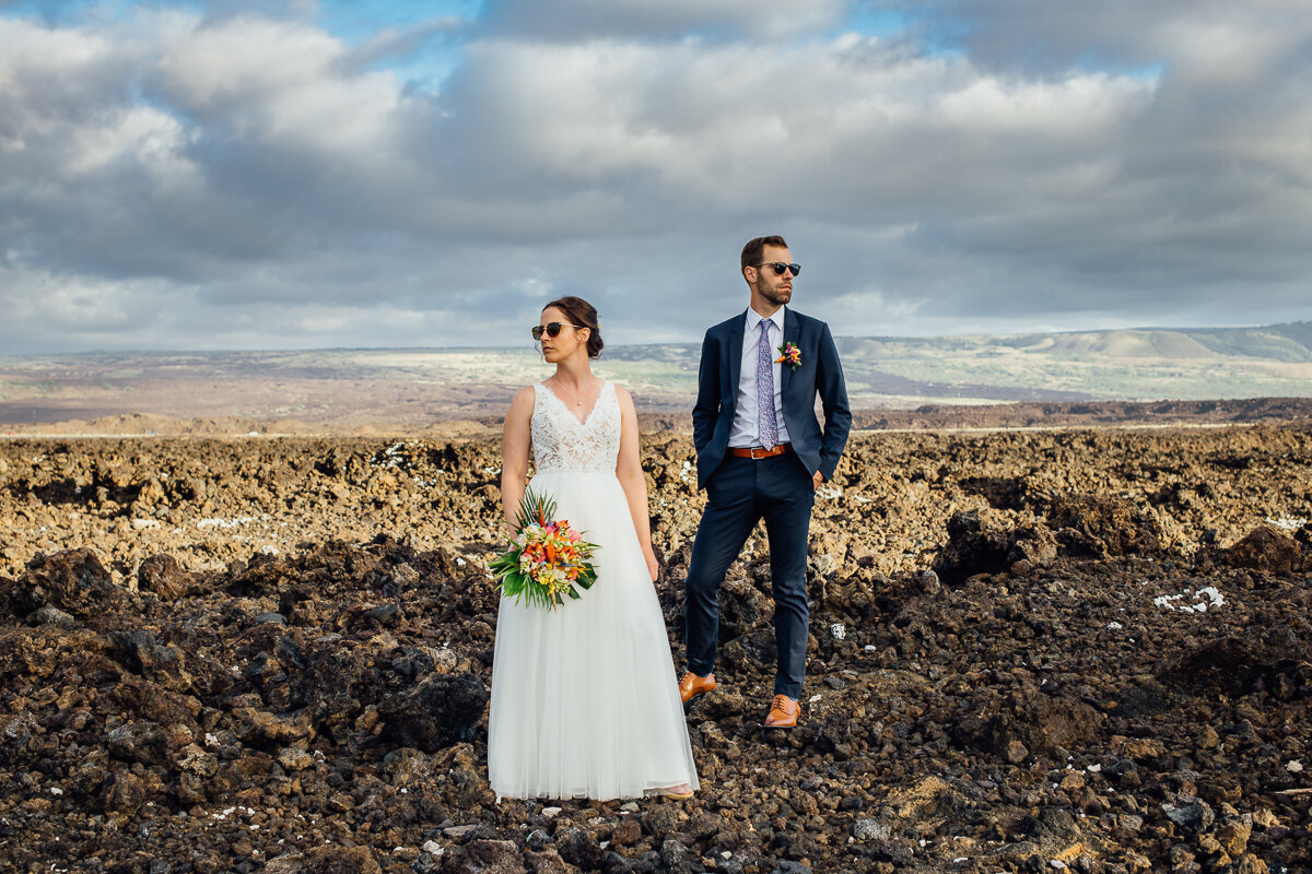 couple posing in the lava rocks during their wedding in hawaii