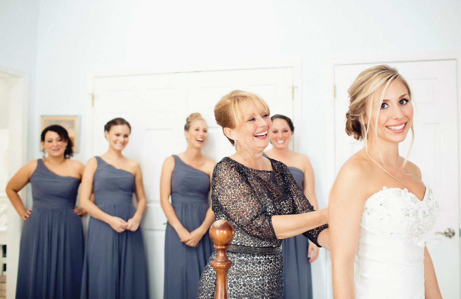Bride gets into dress, Greenville Country Club, Delaware. Kate Timbers Photography.