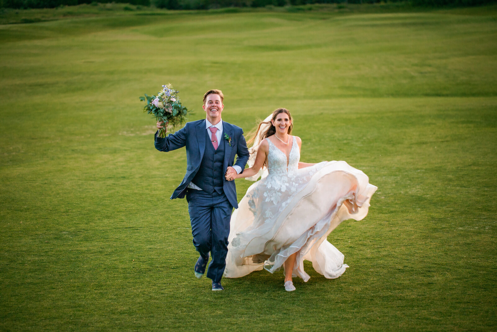 Jackson Hole photographers capture couple running away together after Grand teton wedding