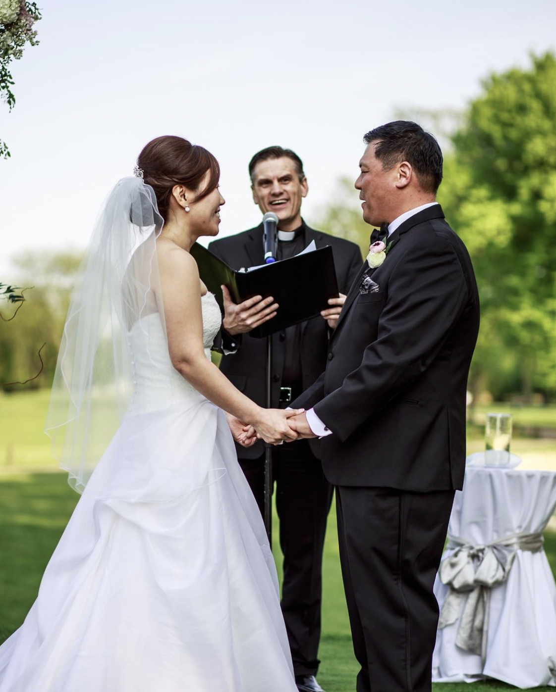 Bride and groom smile while taking their vows