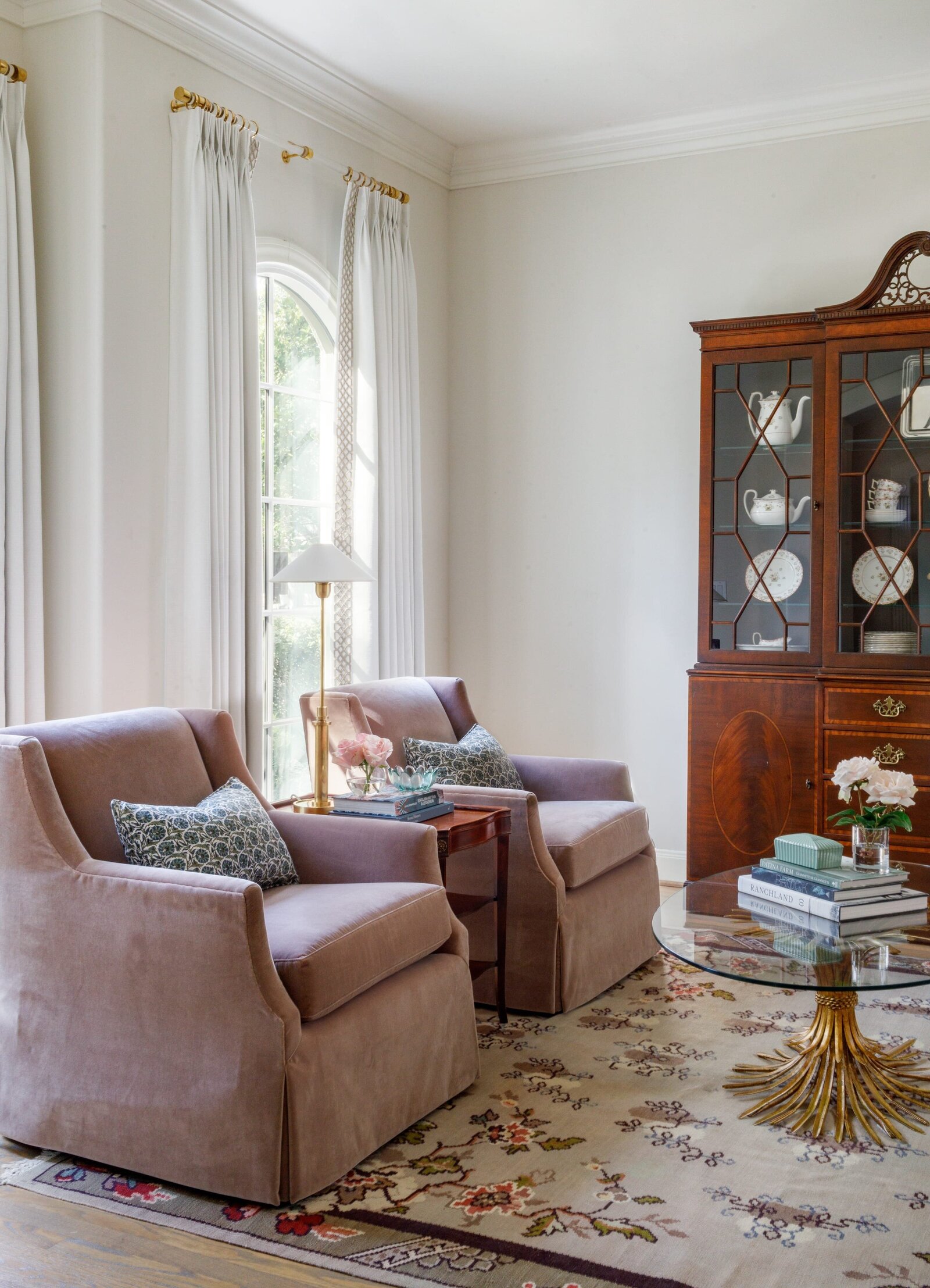 vision and hammer living room with pink chairs and accent rug