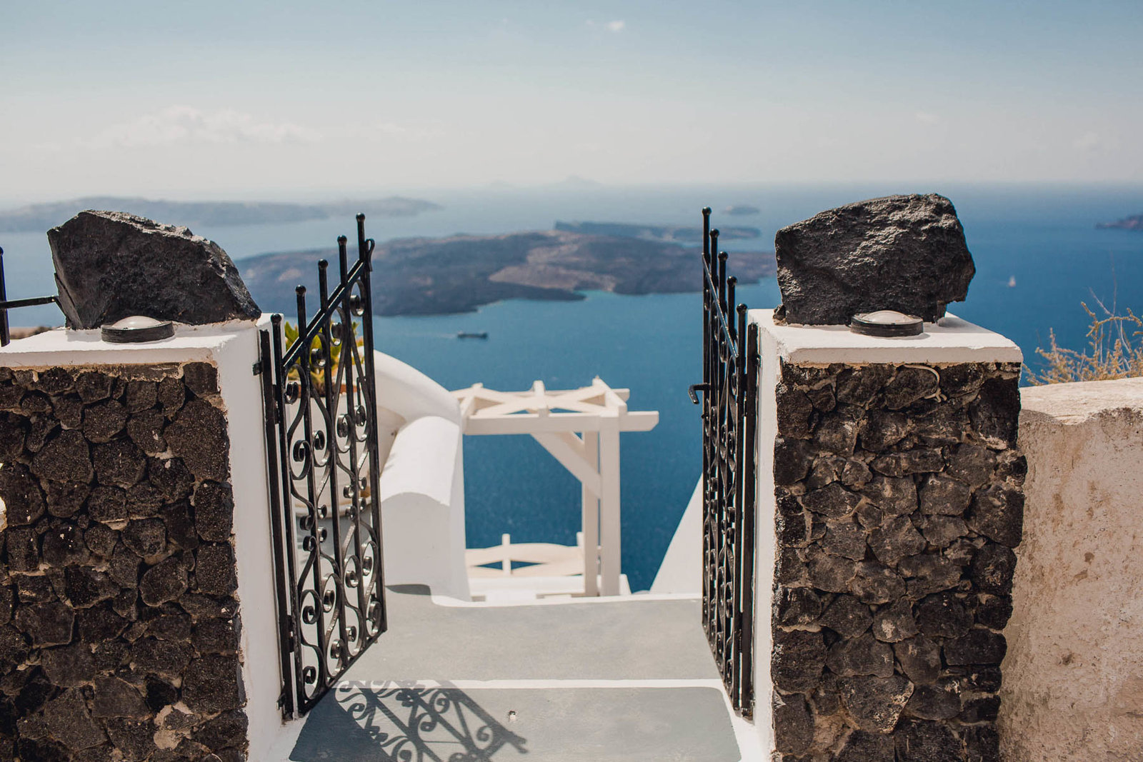 Iron gates leading to a view of the blue ocean, Santorini Island, Greece