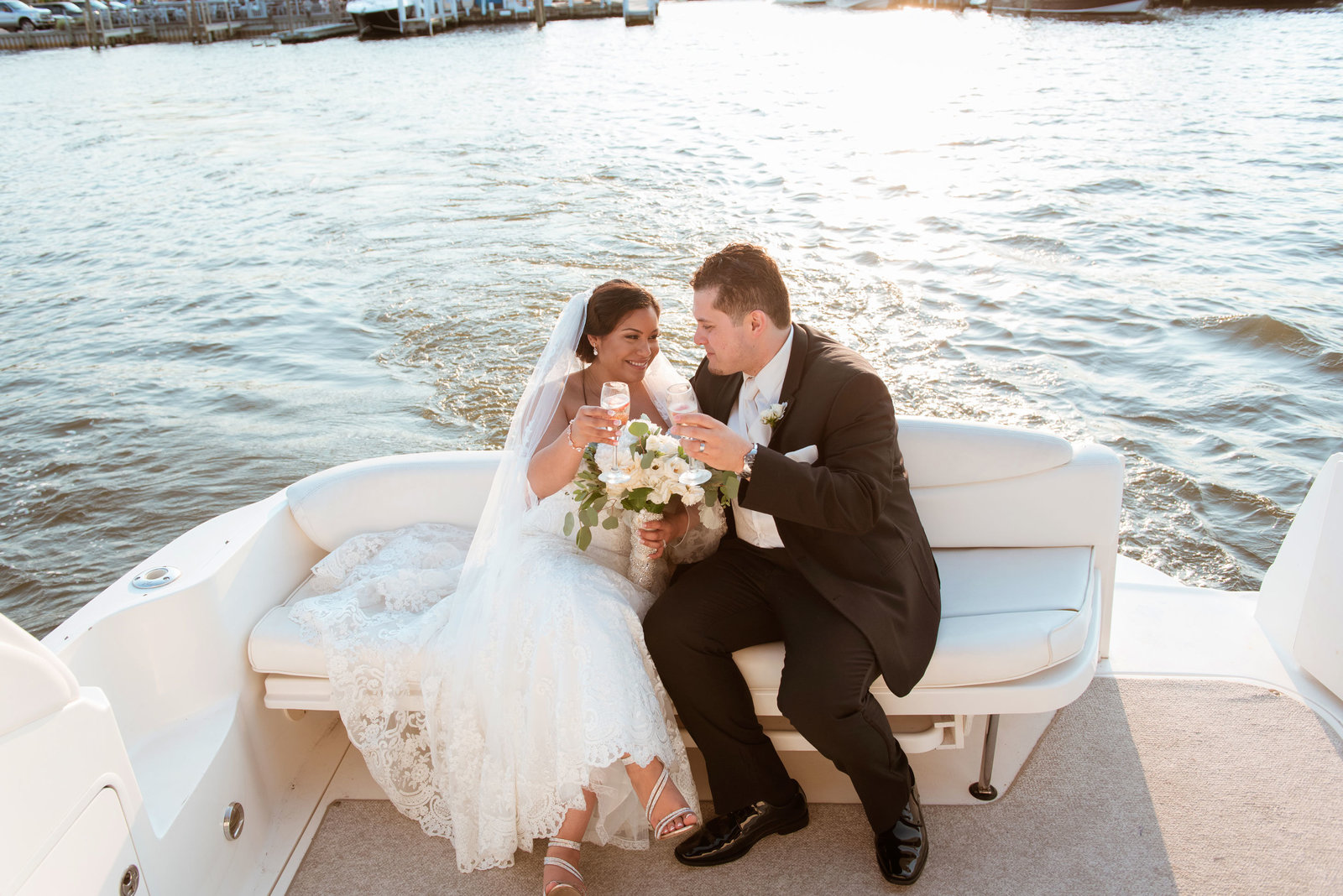 Bride and groom sitting on a boat at Chateau La Mer