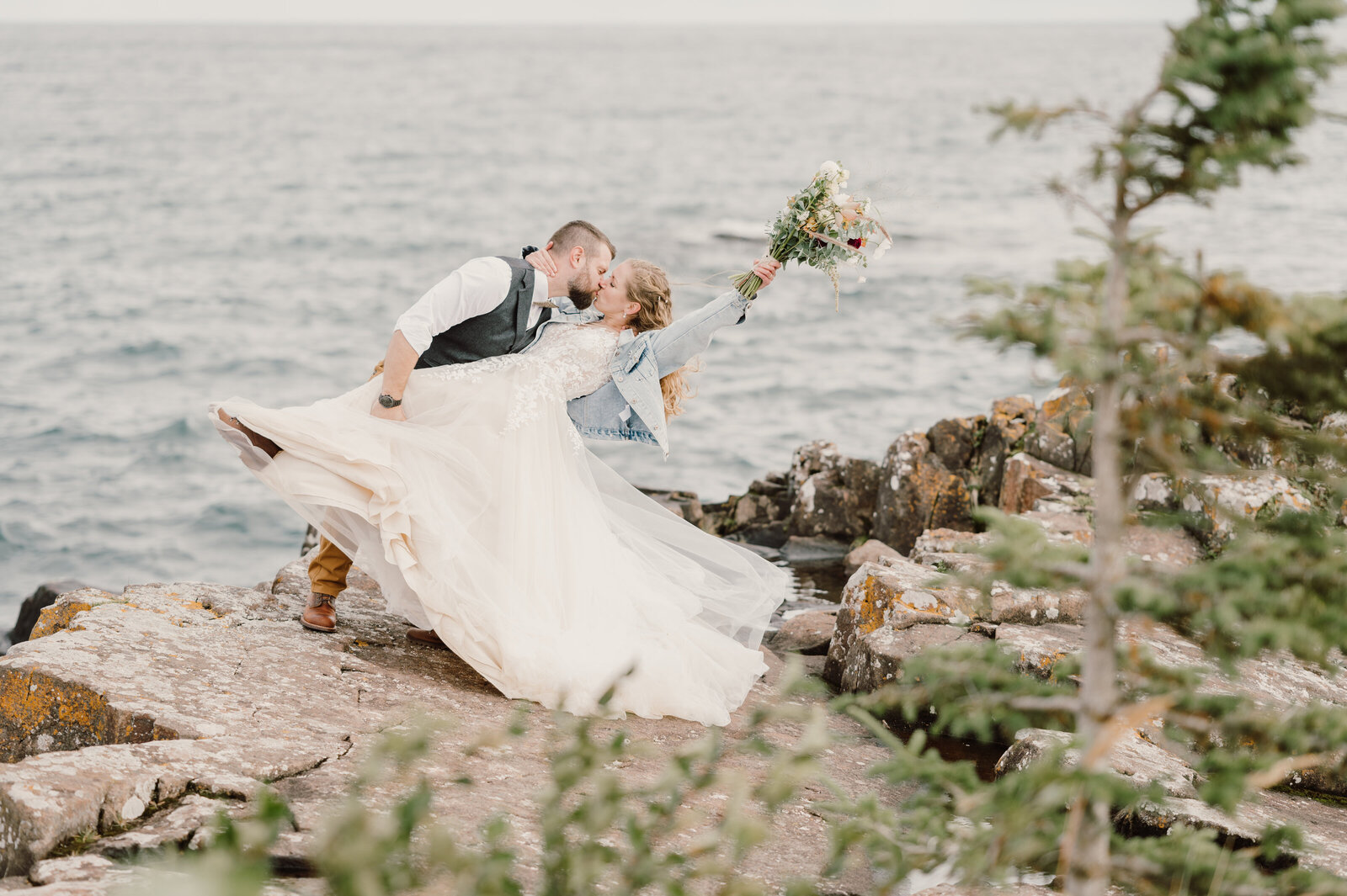 Bride and groom share the kiss on the cliffside