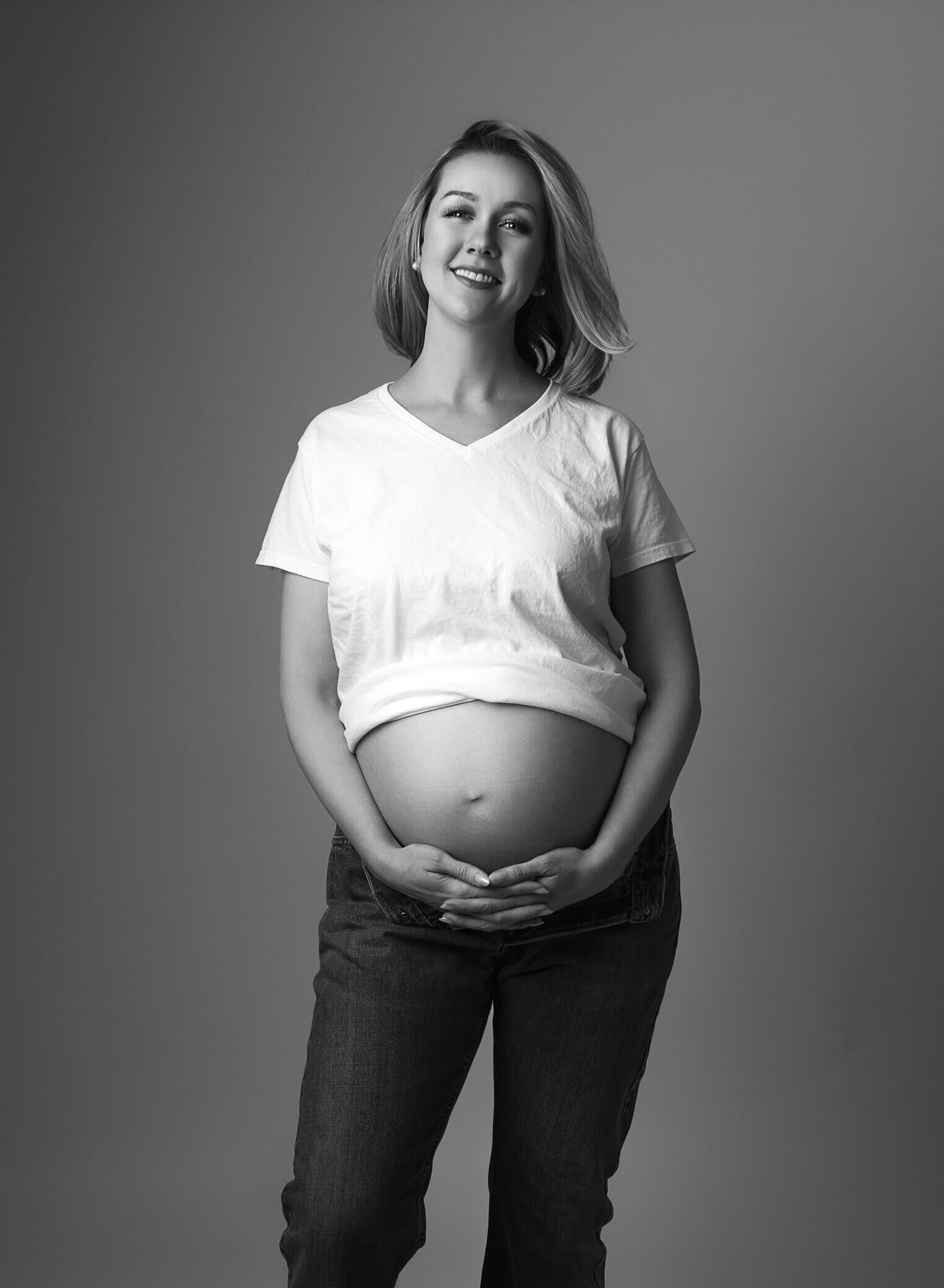 black and white maternity image, jeans and white t-shirt