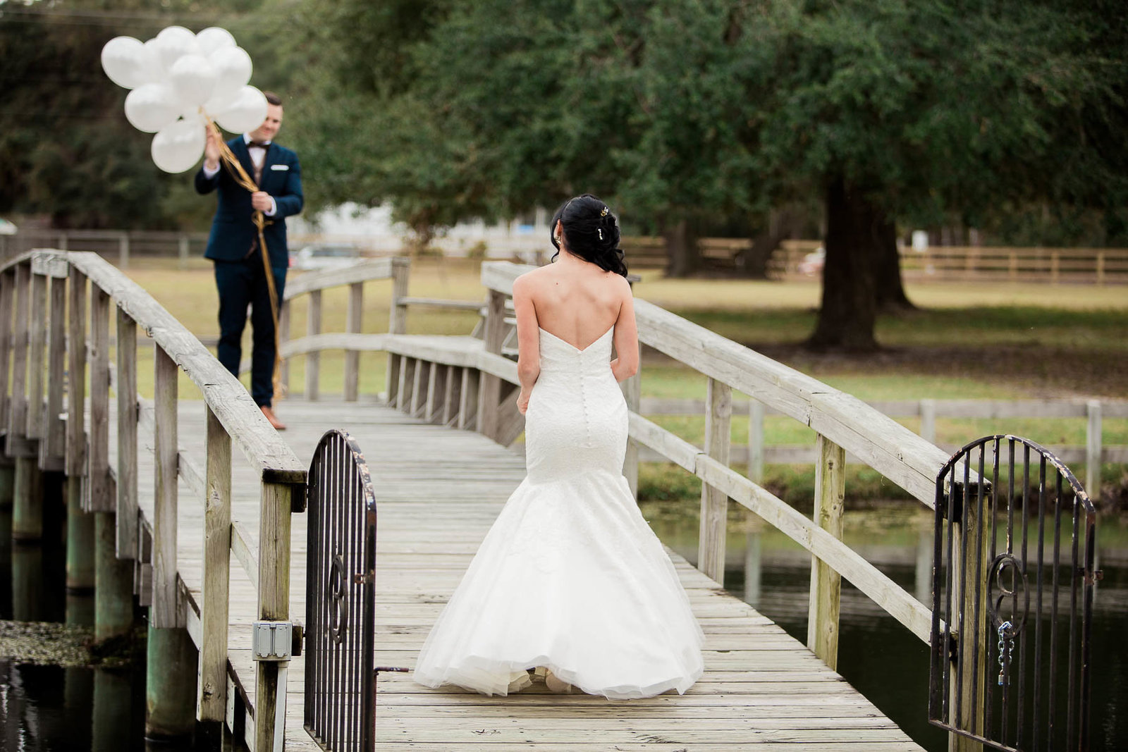 Bride and groom have first look on bridge, Boals Farm, Charleston, South Carolina
