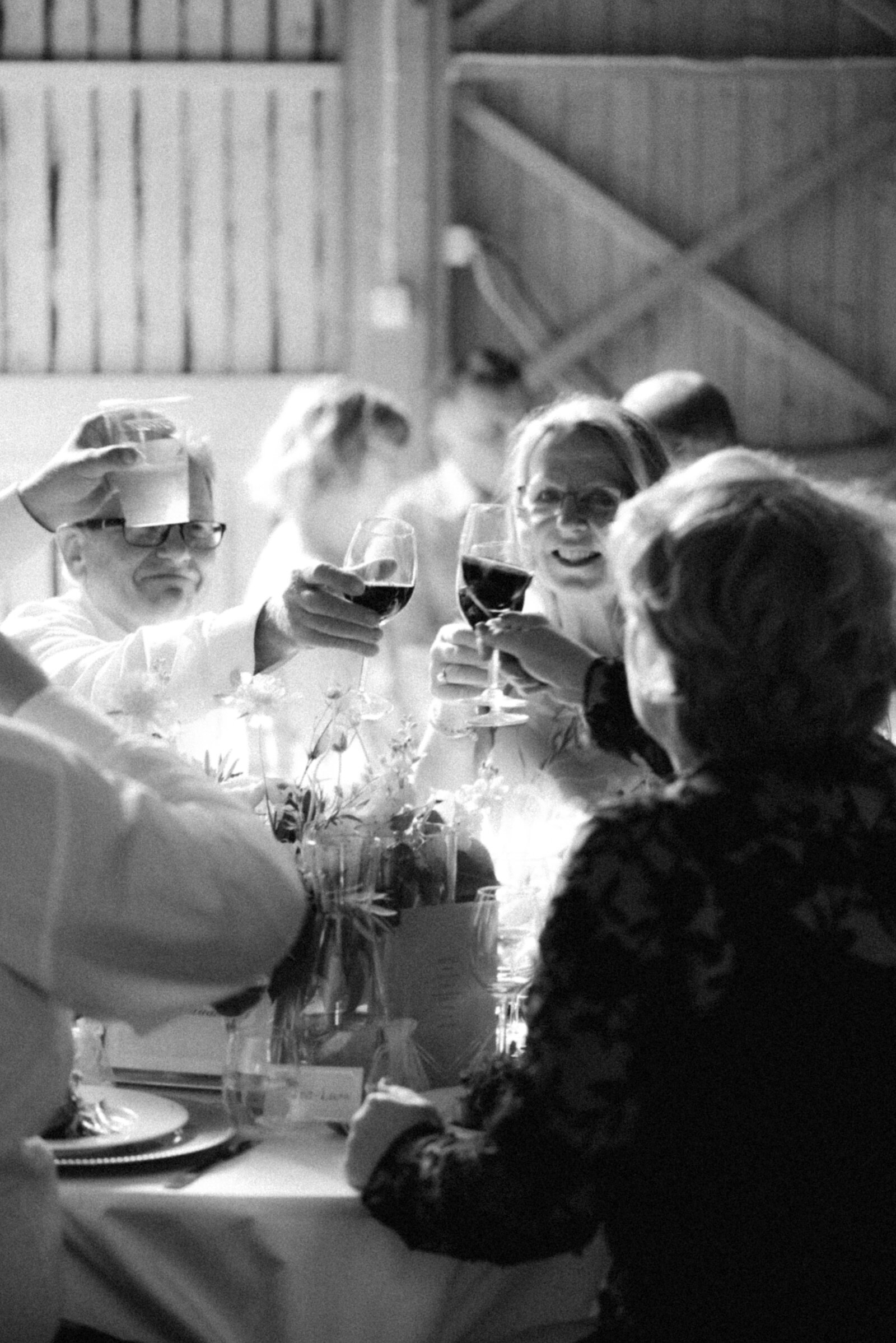 Guests toasting in the wedding in an image captured by wedding photographer Hannika Gabrielsson.