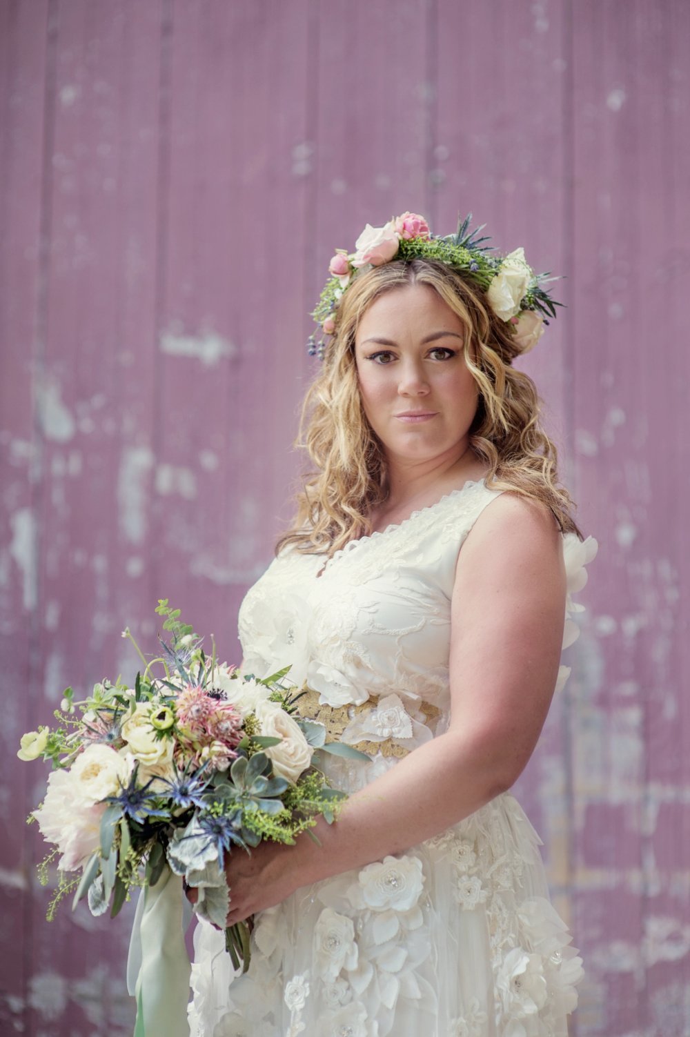 Gorgeous bride with floral crown in a Claire Pettibone gown with rustic bouquet