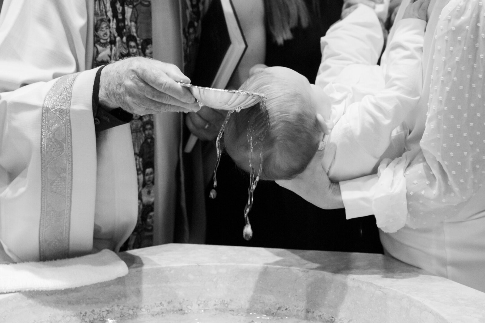 black and white closeup of holy water poured on baby's head Saint Augustine New City Rockland County baptism photographer Milestone Images