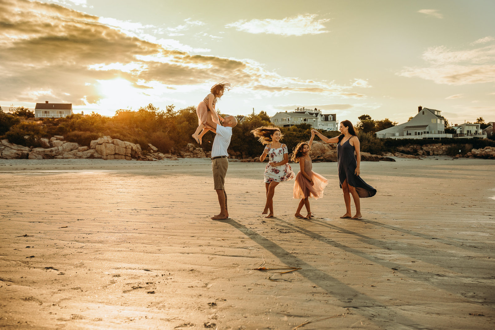 family of five dance on sunset beach in boston family session