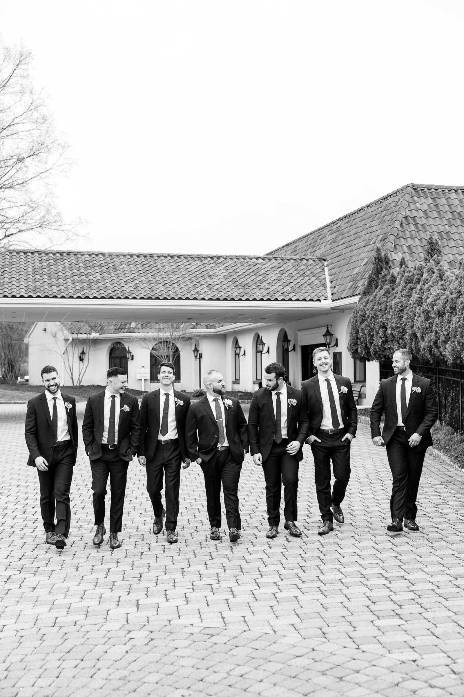 groomsmen walking in suits