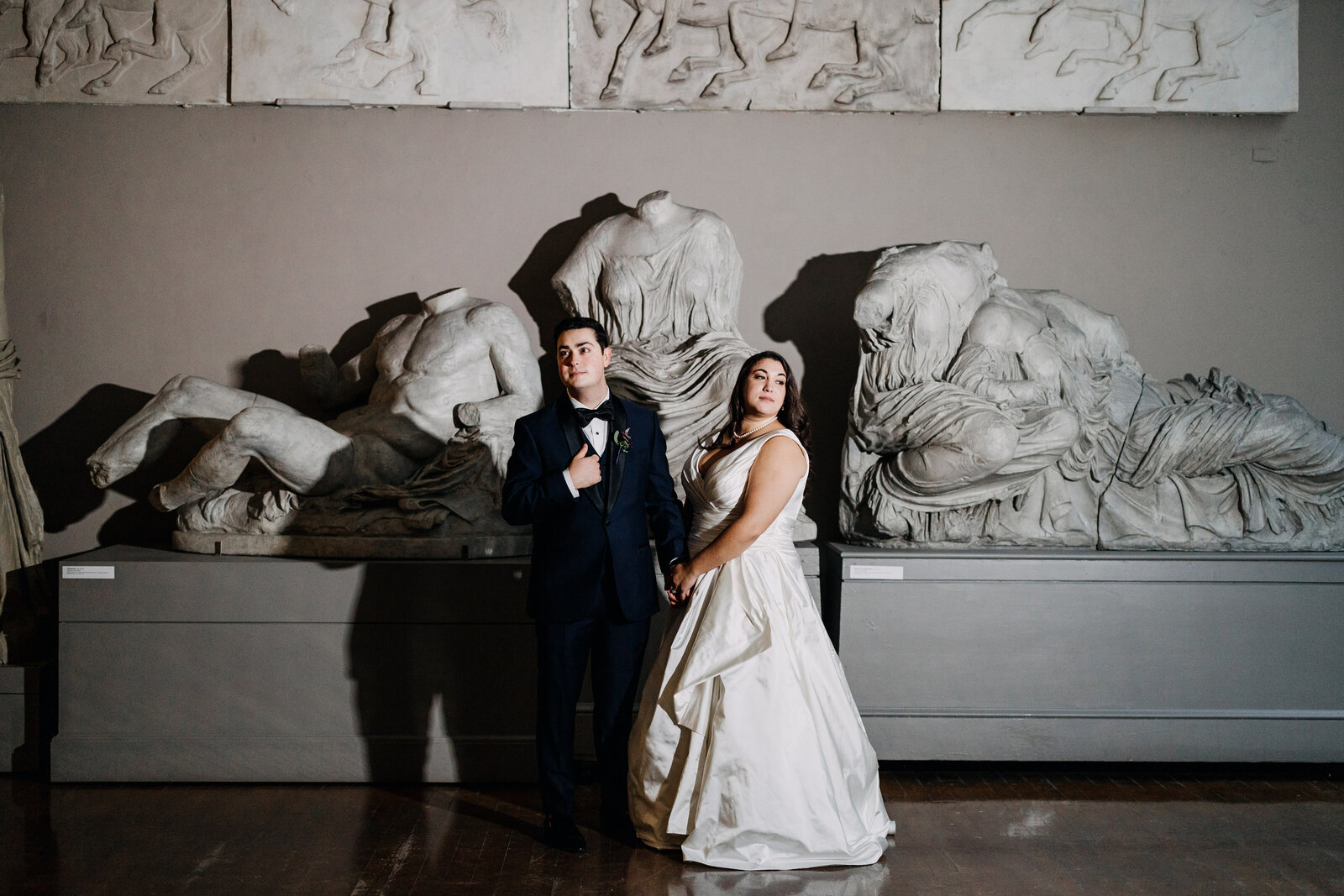 bride and groom with historic sculptures pafa