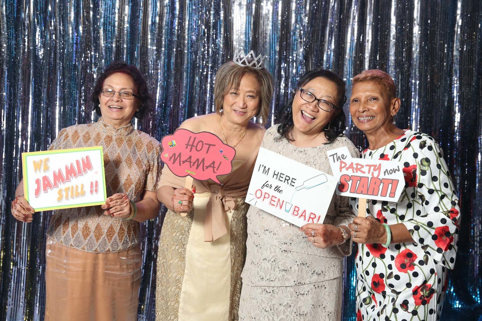 Older ladies holding up funny signs at photobooth. Photo by Ross Photography, Trinidad, W.I..