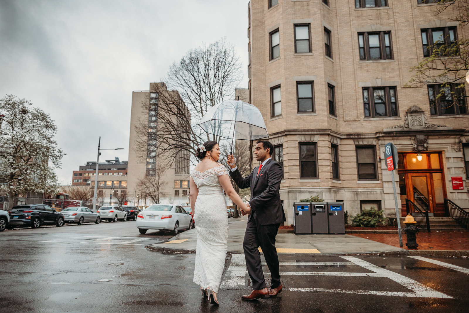 couple walks through boston in rain under umbrella