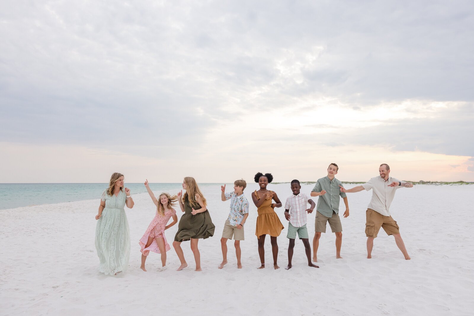 Family of 8 dancing prompt during photo sessions near Fort Pickens