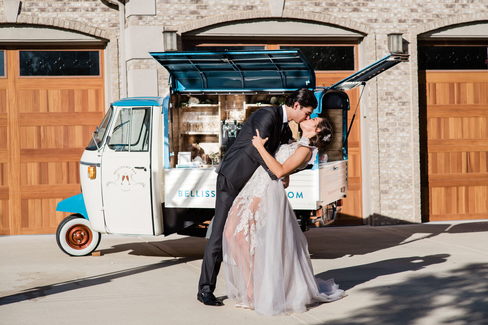 Bride and groom in front of mobile bar cart
