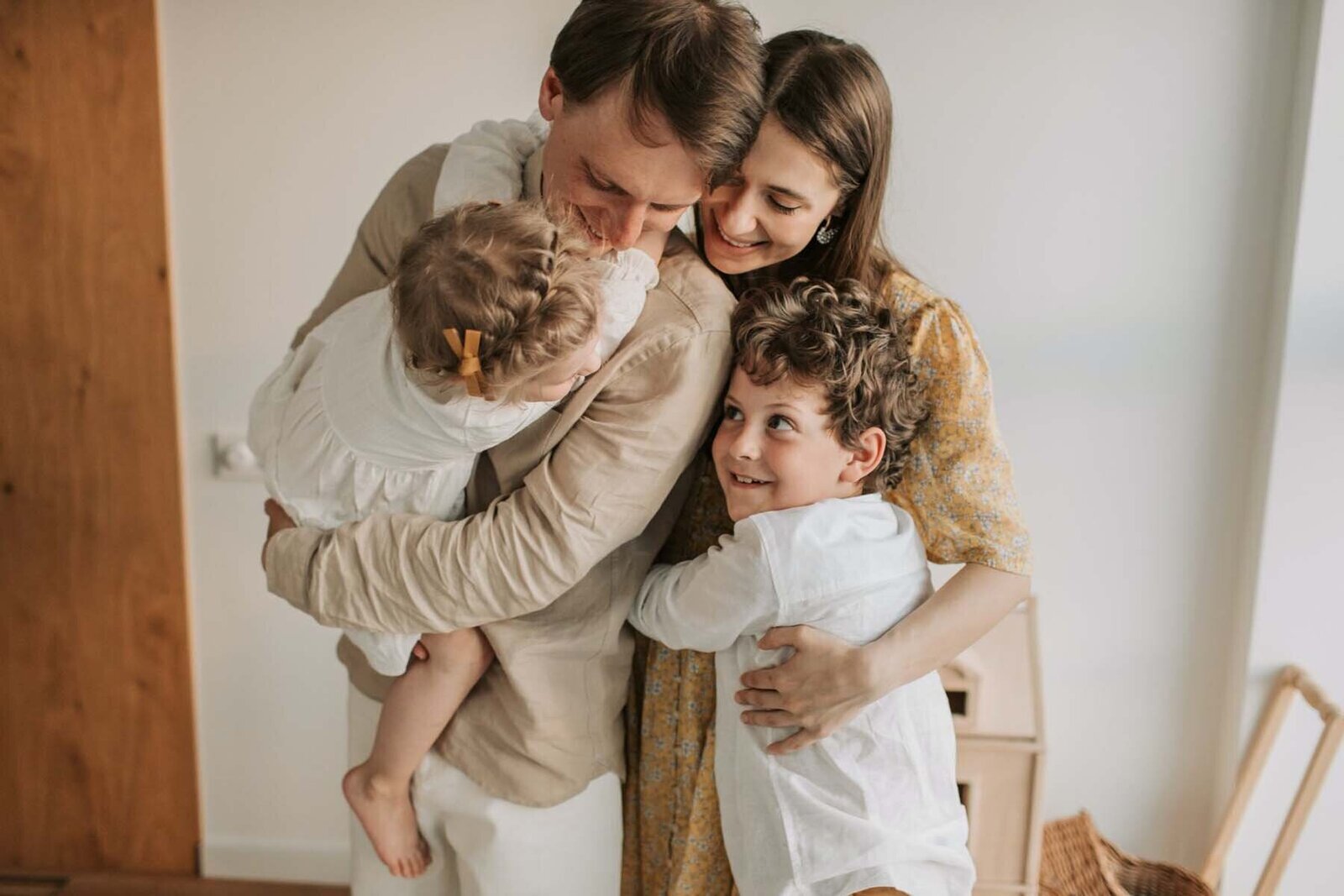 Mom, dad, and kids share a joyful moment, embodying the harmonious family life fostered by peaceful parenting principles