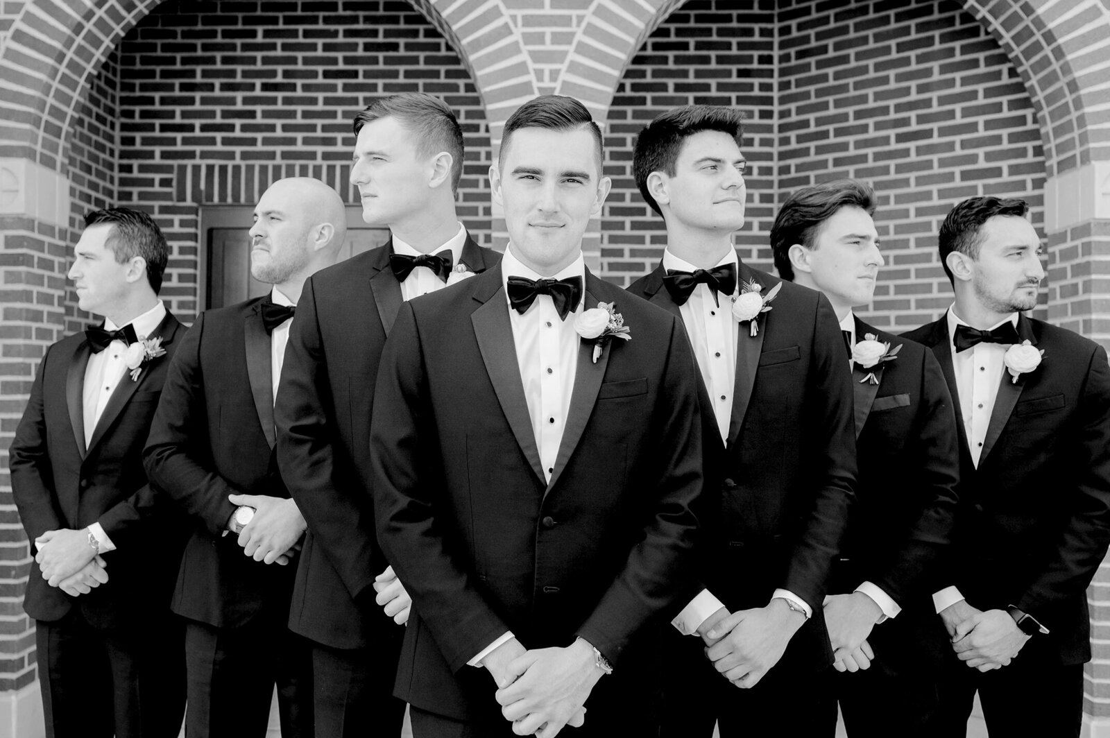 Black and White photo of groomsmen all lined up together