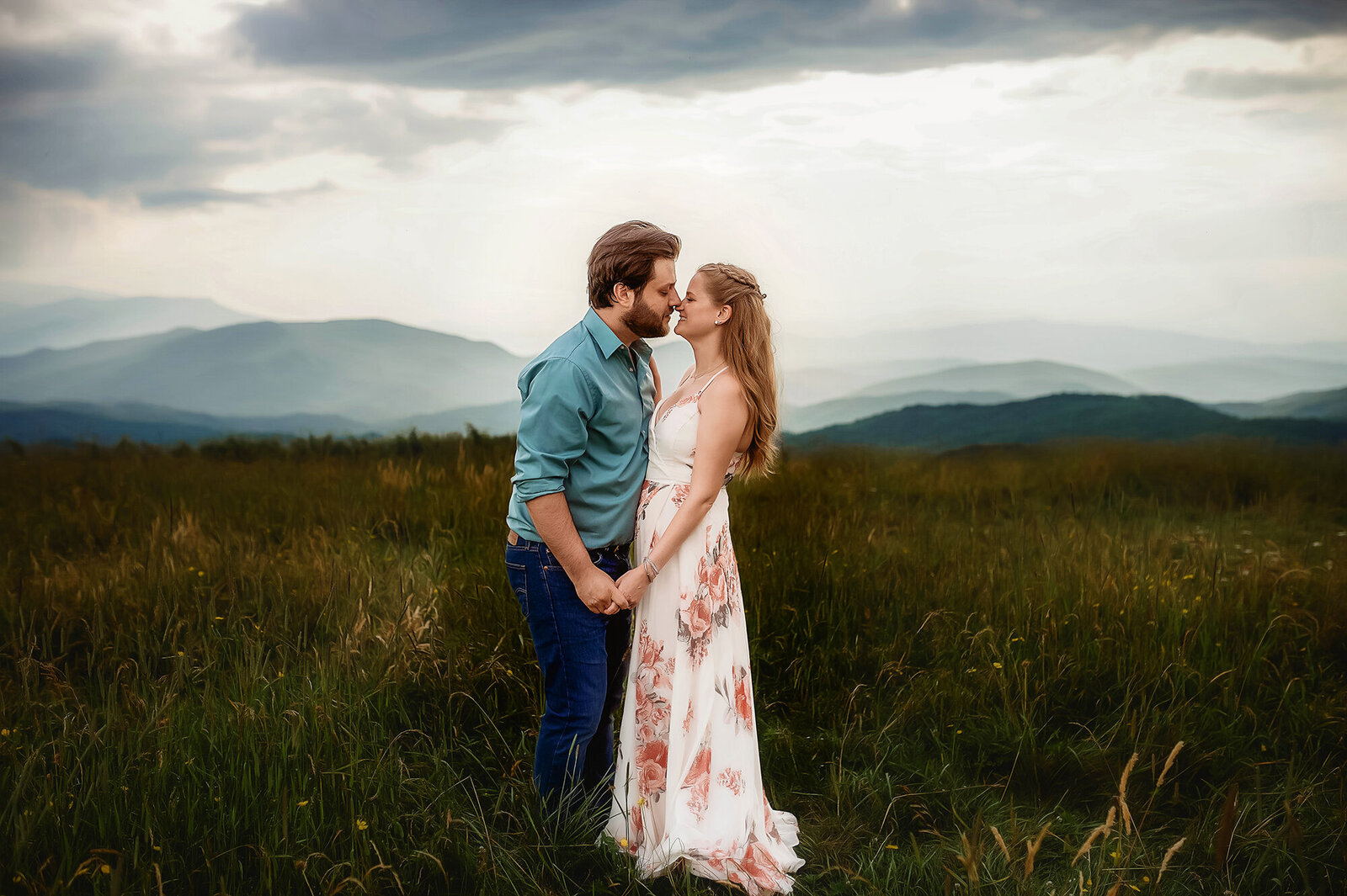 A couple in love poses for Engagement Photos on a mountain top in Asheville, NC.