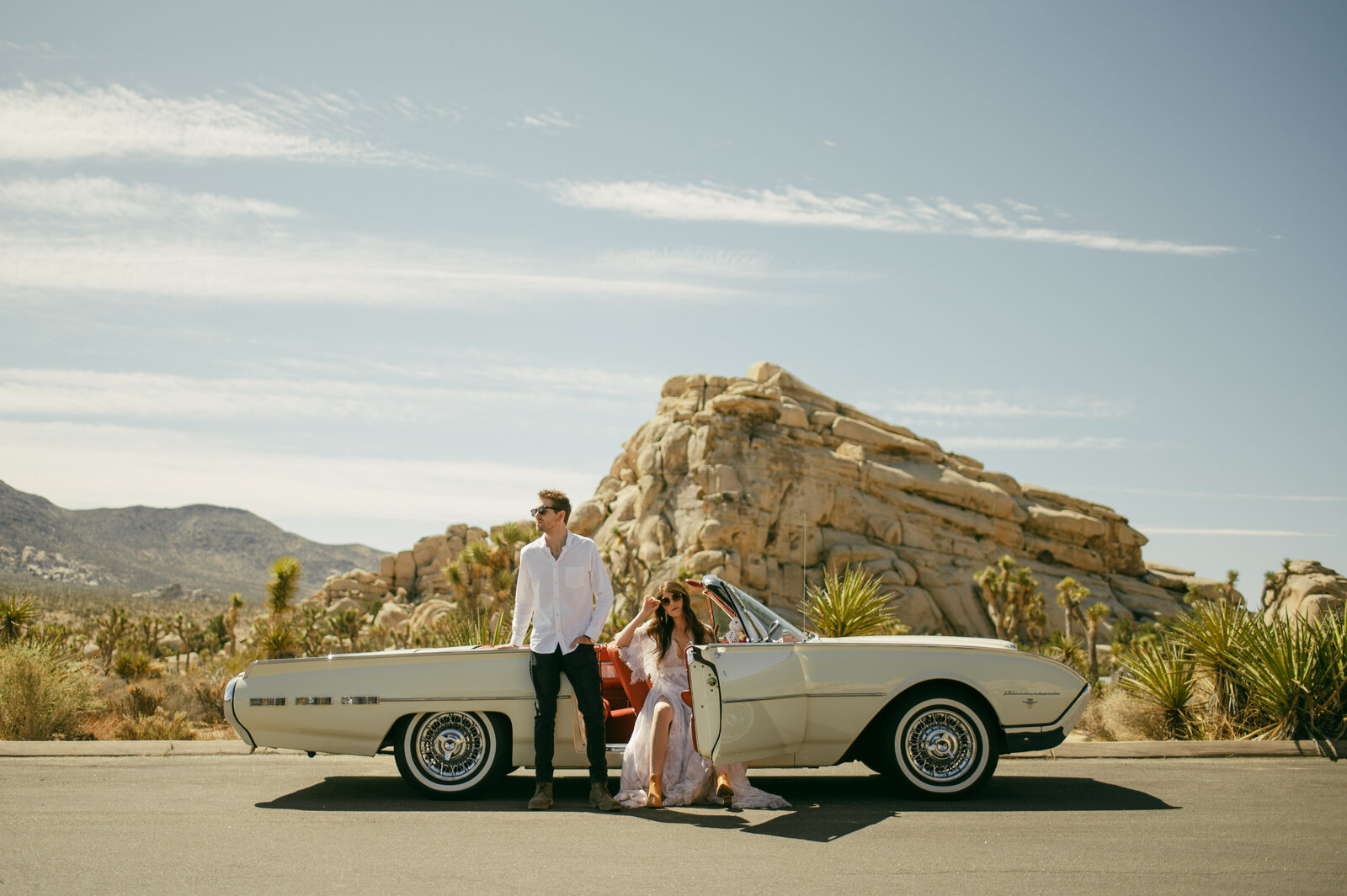 A wedding couple in a retro photoshoot with a classic car in Joshua Tree National Park