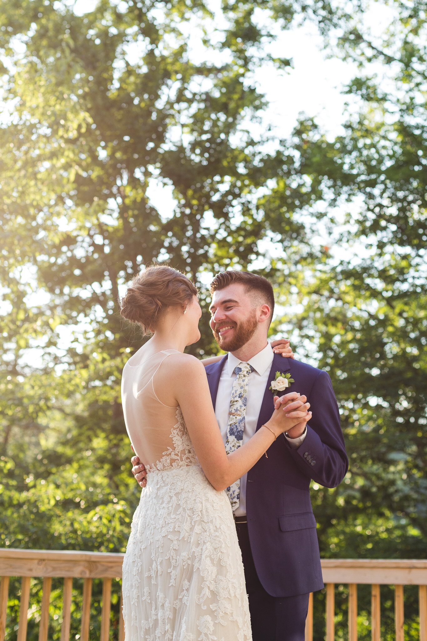 bride and groom first dance on deck during golden hour for micro wedding